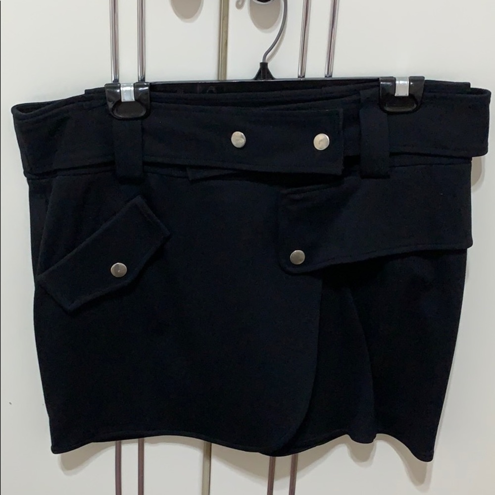 Short black skirt silver button detail